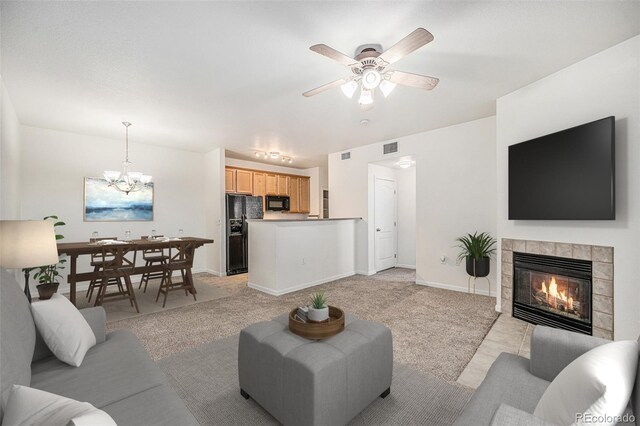 10149 W 55th Dr Unit 3, Arvada, CO 80002 - living area featuring light carpet, a fireplace, a chandelier, ceiling fan, and baseboards