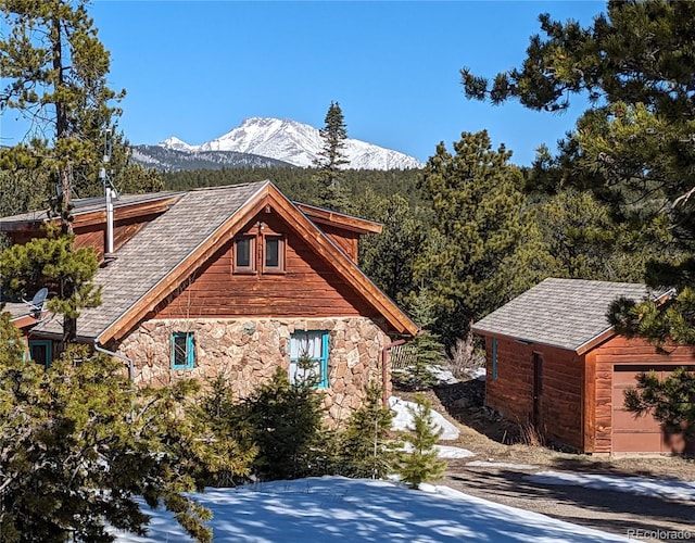 600 Rock Lake Rd, Ward, CO 80481 - view of side of home with stone siding, a mountain view, and an outdoor structure