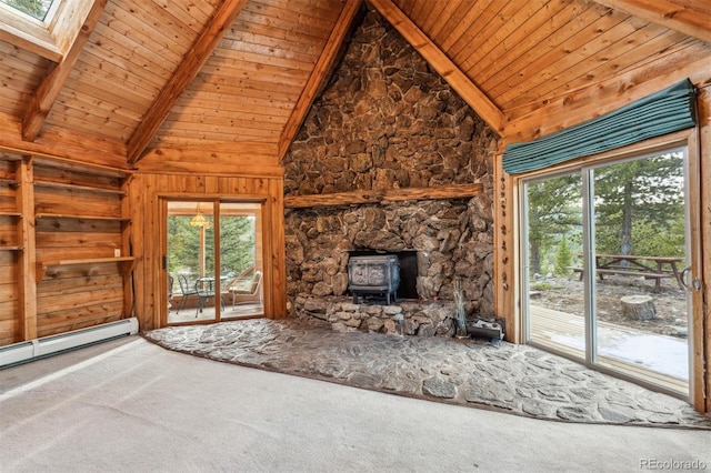 600 Rock Lake Rd, Ward, CO 80481 - unfurnished living room featuring baseboard heating, wood ceiling, carpet floors, a wood stove, and vaulted ceiling with skylight
