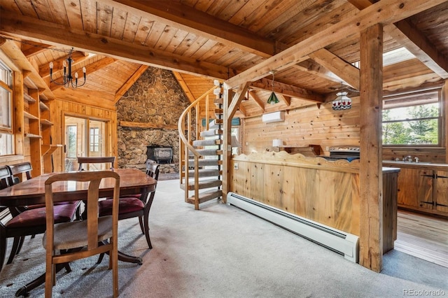 600 Rock Lake Rd, Ward, CO 80481 - carpeted dining room featuring baseboard heating, wood ceiling, stairs, wooden walls, and vaulted ceiling with beams