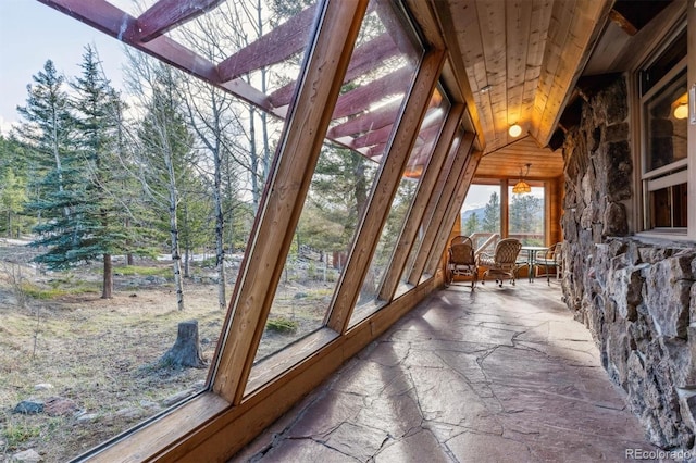 600 Rock Lake Rd, Ward, CO 80481 - unfurnished sunroom featuring stone floors and wood ceiling