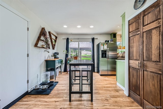 18662 E Brown Pl, Aurora, CO 80013 - kitchen featuring stainless steel fridge with ice dispenser, light wood-style floors, and recessed lighting