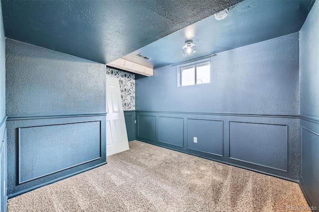 18662 E Brown Pl, Aurora, CO 80013 - unfurnished room featuring a decorative wall, carpet, a textured wall, and wainscoting