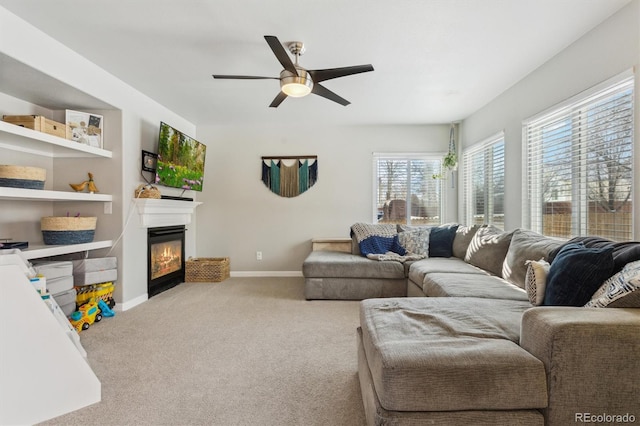 carpeted living room with ceiling fan