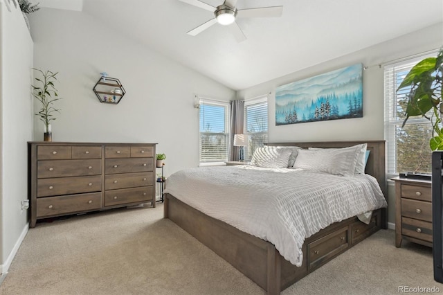 bedroom with multiple windows, vaulted ceiling, light colored carpet, and ceiling fan