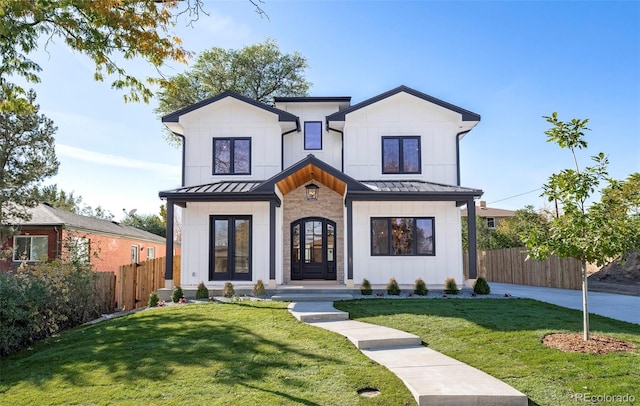 modern farmhouse with french doors and a front lawn