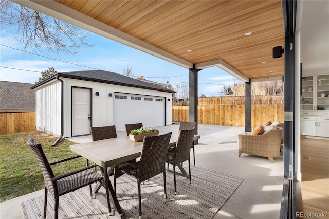 view of patio with an outbuilding and a garage