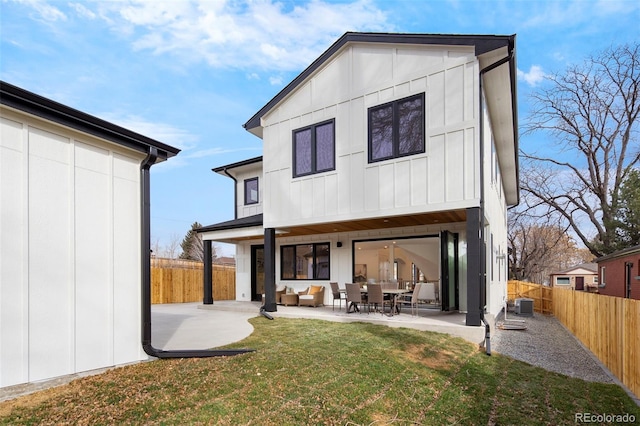 back of property with a patio, outdoor lounge area, a yard, and central AC unit