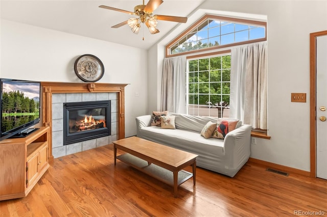 131 Morgan Ct, Loveland, CO 80537 - living area featuring a ceiling fan, a tile fireplace, light wood-type flooring, and lofted ceiling