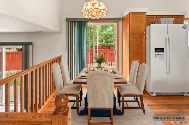 131 Morgan Ct, Loveland, CO 80537 - dining room with a chandelier and light wood-style flooring