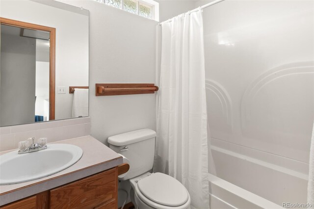 131 Morgan Ct, Loveland, CO 80537 - bathroom featuring vanity, shower / bath combination with curtain, and backsplash