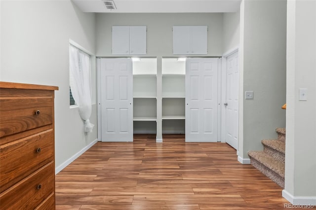 131 Morgan Ct, Loveland, CO 80537 - unfurnished bedroom featuring light wood finished floors and multiple closets