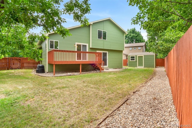 131 Morgan Ct, Loveland, CO 80537 - back of property with a deck, a fenced backyard, and a storage shed
