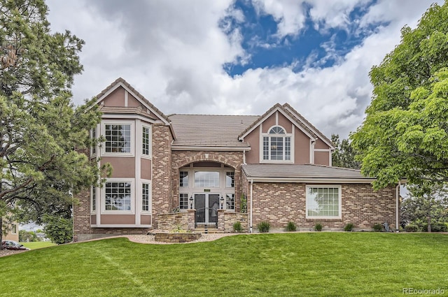 7758 Edgewater Ct, Lone Tree, CO 80124 - view of front of property with stucco siding, a front lawn, and a tiled roof