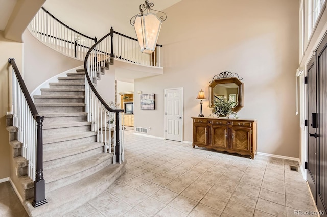 7758 Edgewater Ct, Lone Tree, CO 80124 - entrance foyer featuring a towering ceiling, stairway, baseboards, and tile patterned flooring