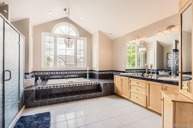 7758 Edgewater Ct, Lone Tree, CO 80124 - full bathroom featuring vaulted ceiling, tile patterned floors, a chandelier, a bath, and double vanity