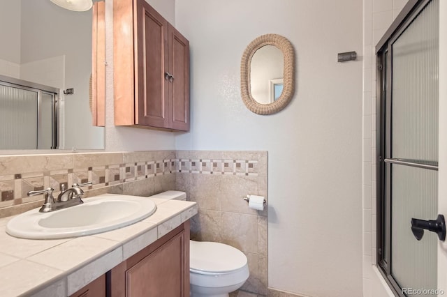 7758 Edgewater Ct, Lone Tree, CO 80124 - full bathroom featuring a shower with door, toilet, vanity, and tile walls