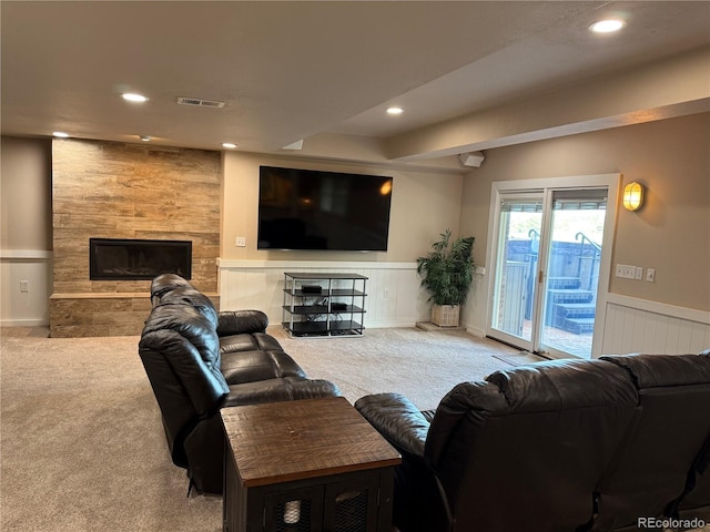 7758 Edgewater Ct, Lone Tree, CO 80124 - carpeted living room featuring recessed lighting, wainscoting, and a stone fireplace