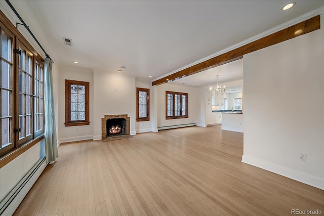 371 Birch St, Denver, CO 80220 - unfurnished living room featuring light wood finished floors, baseboard heating, baseboards, and a chandelier