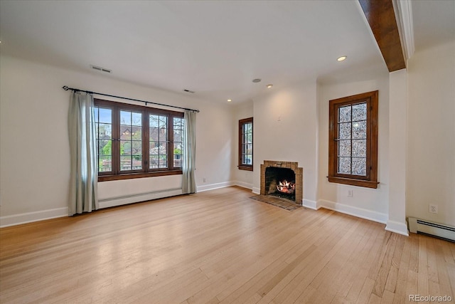 371 Birch St, Denver, CO 80220 - unfurnished living room featuring a baseboard heating unit, plenty of natural light, visible vents, and light wood-style floors