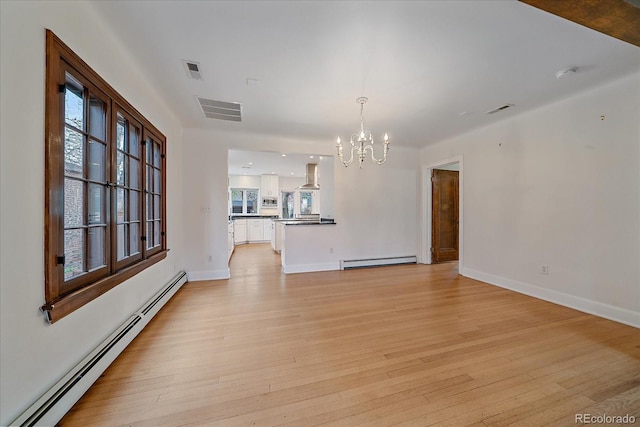 371 Birch St, Denver, CO 80220 - unfurnished living room featuring a baseboard heating unit, baseboard heating, visible vents, and an inviting chandelier