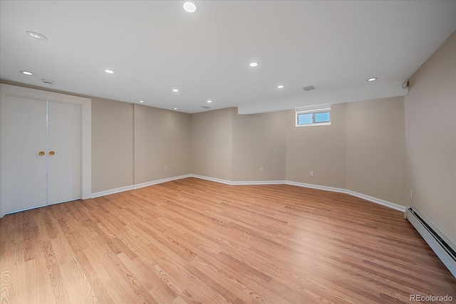 371 Birch St, Denver, CO 80220 - basement with a baseboard heating unit, light wood finished floors, baseboards, and recessed lighting