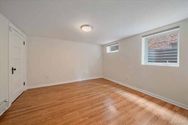 371 Birch St, Denver, CO 80220 - empty room with light wood-style flooring, baseboards, and a baseboard radiator