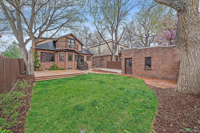 371 Birch St, Denver, CO 80220 - rear view of property featuring brick siding, fence private yard, a lawn, and entry steps