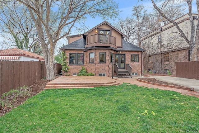 371 Birch St, Denver, CO 80220 - view of front facade with roof with shingles, a fenced backyard, brick siding, a balcony, and a front yard