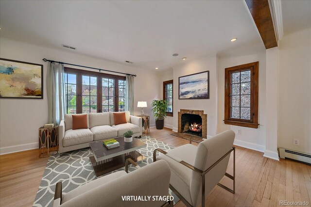371 Birch St, Denver, CO 80220 - living room featuring baseboards, a healthy amount of sunlight, visible vents, and light wood-type flooring