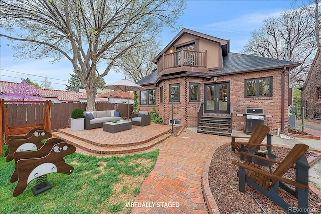 371 Birch St, Denver, CO 80220 - back of property with a balcony, french doors, a fenced backyard, a patio, and an outdoor hangout area