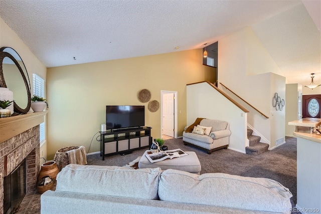 living room featuring a brick fireplace, a textured ceiling, high vaulted ceiling, and dark colored carpet