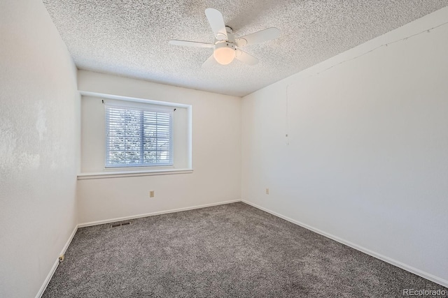 carpeted empty room with ceiling fan and a textured ceiling