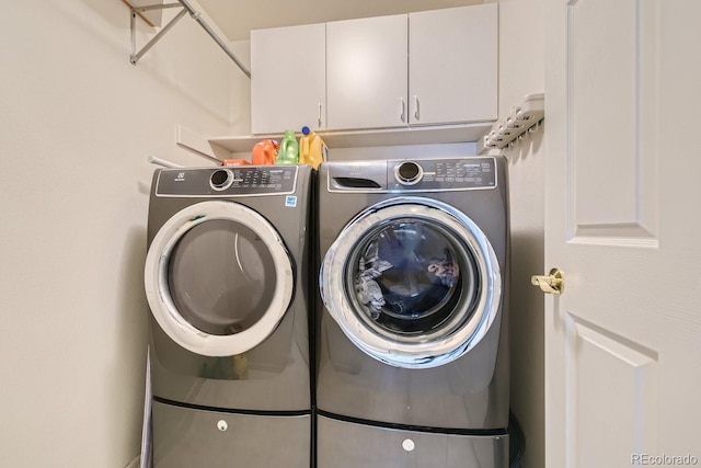 laundry area featuring cabinets and separate washer and dryer