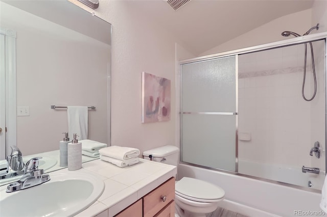 bathroom with lofted ceiling, toilet, visible vents, vanity, and combined bath / shower with glass door