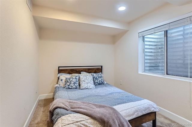 carpeted bedroom featuring baseboards