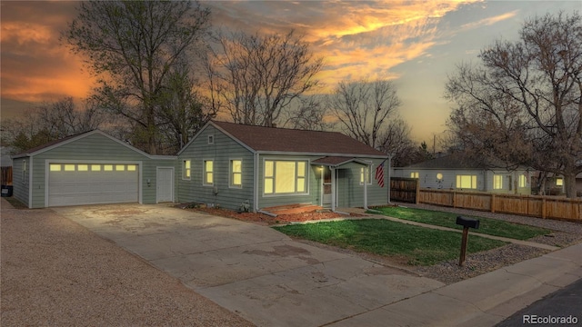 view of front facade with fence, a front lawn, and concrete driveway