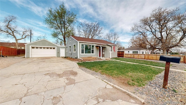 view of front of property with an outbuilding, concrete driveway, fence, a front lawn, and a garage