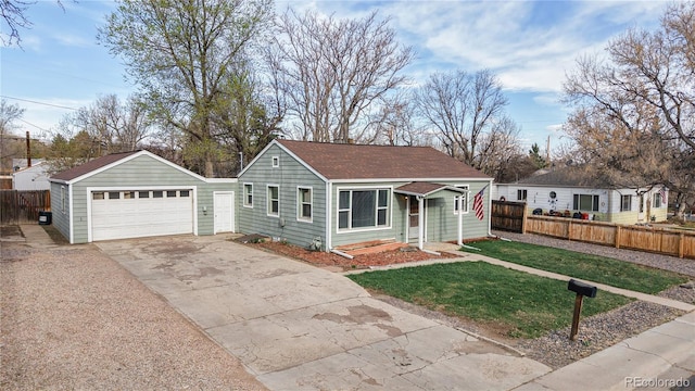 view of front of home with a garage, fence, a front lawn, and a shingled roof