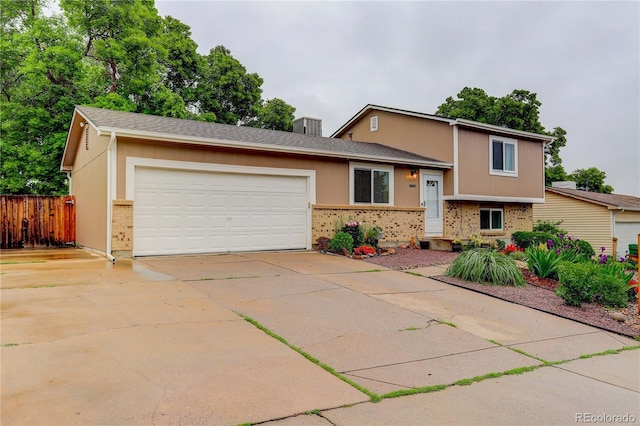 10527 Pierson Cir, Westminster, CO 80021 - split level home with brick siding, a garage, and driveway