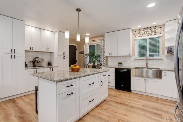 10527 Pierson Cir, Westminster, CO 80021 - kitchen with dishwasher, a sink, tasteful backsplash, plenty of natural light, and recessed lighting