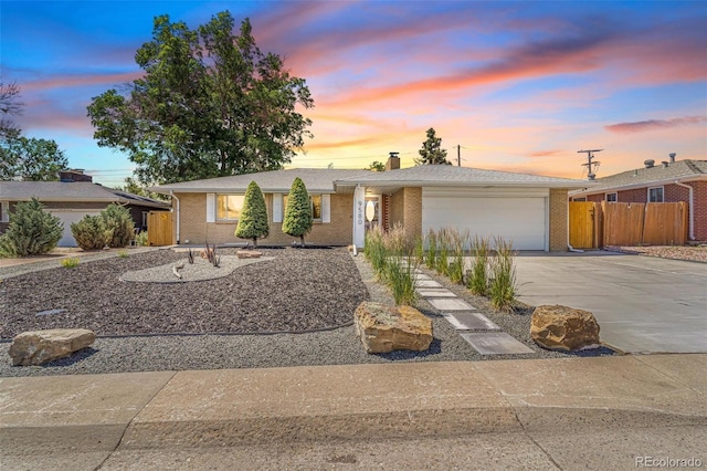 9580 W 51st Ave, Arvada, CO 80002 - ranch-style house with concrete driveway, a garage, a chimney, and brick siding