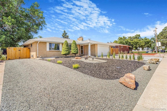 9580 W 51st Ave, Arvada, CO 80002 - ranch-style house with concrete driveway, a garage, brick siding, and a chimney