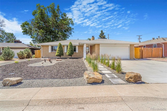 9580 W 51st Ave, Arvada, CO 80002 - single story home with concrete driveway, a chimney, a garage, and brick siding