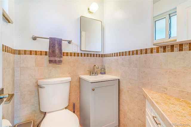 9580 W 51st Ave, Arvada, CO 80002 - bathroom with tile walls, vanity, and a wainscoted wall