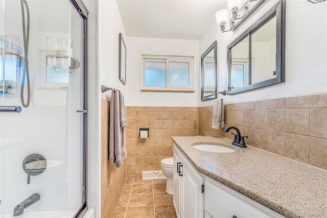 9580 W 51st Ave, Arvada, CO 80002 - bathroom with vanity, tile walls, and a wainscoted wall