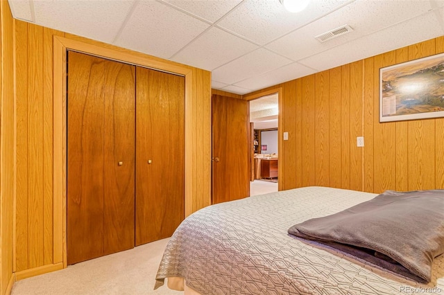 9580 W 51st Ave, Arvada, CO 80002 - bedroom with carpet floors, a closet, wooden walls, and a paneled ceiling