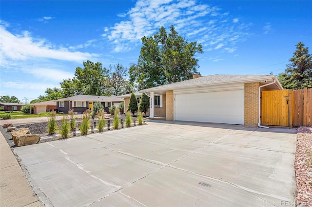 9580 W 51st Ave, Arvada, CO 80002 - single story home with brick siding, concrete driveway, a garage, and a chimney