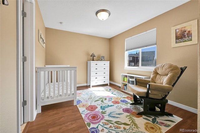 bedroom with baseboards and wood finished floors