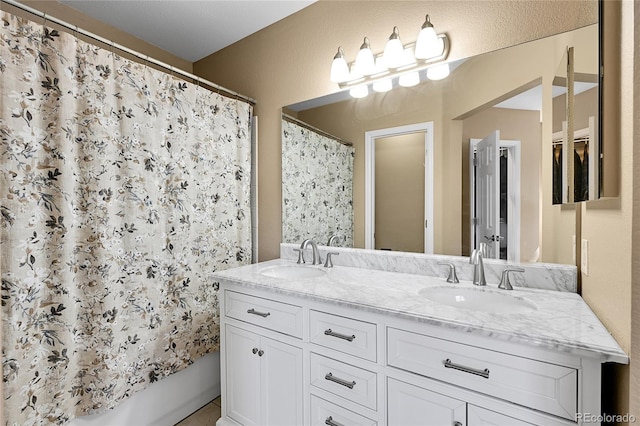 full bath featuring double vanity, shower / bathtub combination with curtain, and a sink